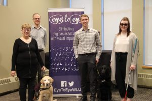 Jack McCormick and his guide dog Jake, center, at a recent “Eye To Eye” event Jack organized at his college. On the left is Dr. Penny Hartin, CEO of the World Blind Union, the guest speaker at the event.